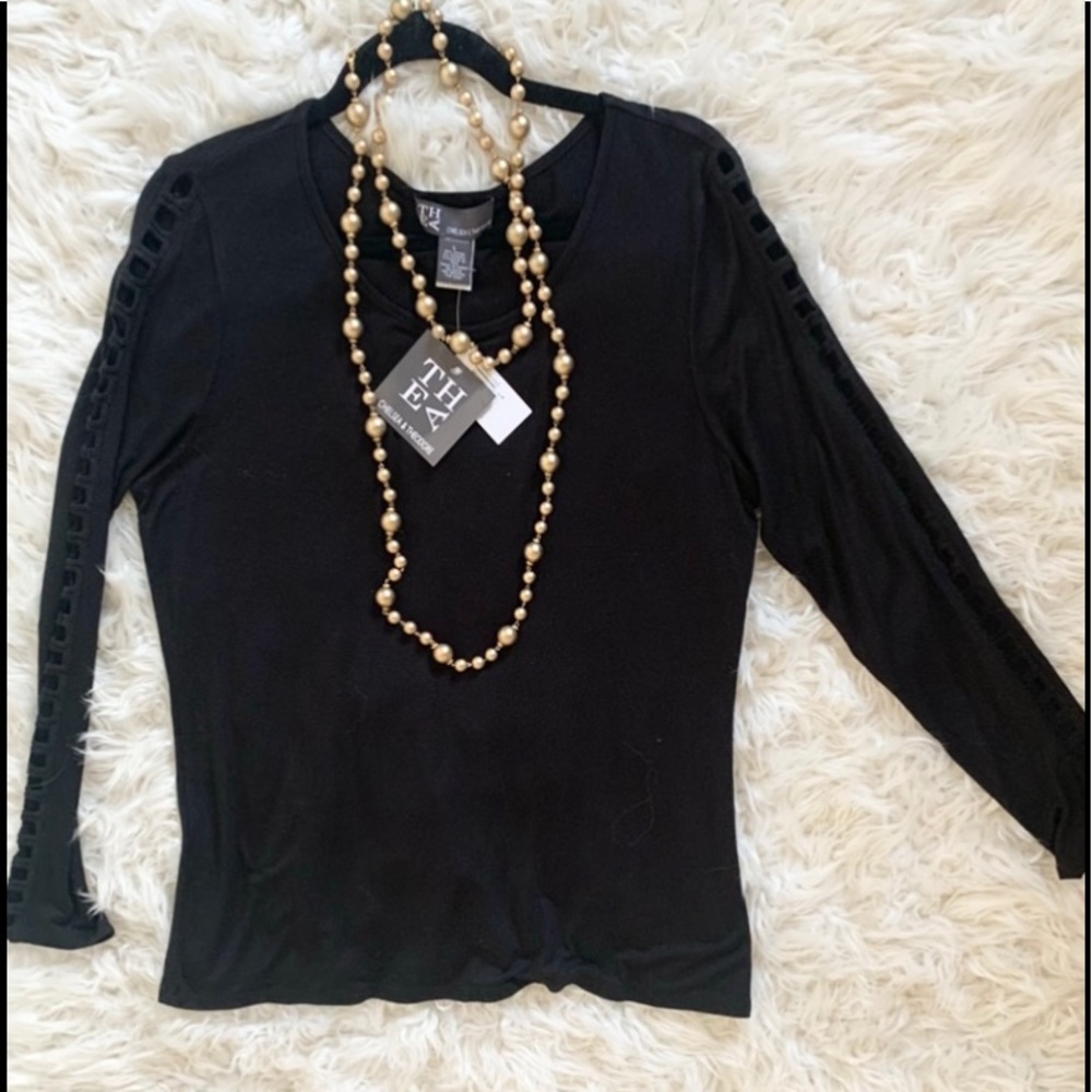 Black top with detailing on the arms.